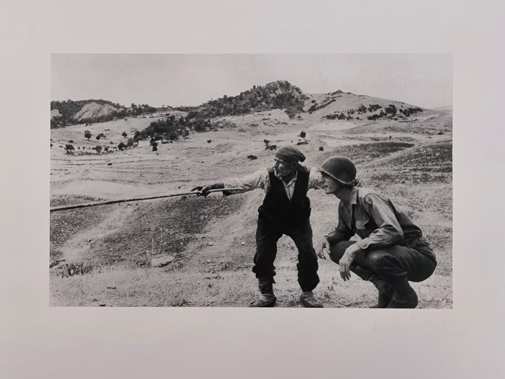 Robert Capa (1913–1954) - Sicilian peasant telling an American officer which way the Germans had gone. Near Troina. Italy. #1.0