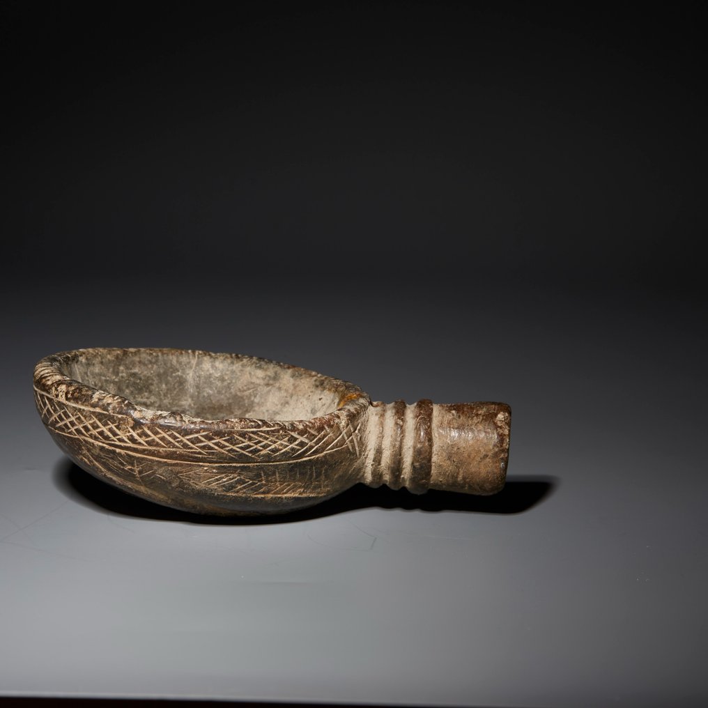 Näröstlig Grå klorit Libation plate med en hand på baksidan. ca. 800 f.Kr. 10,6 cm längd. #4.3