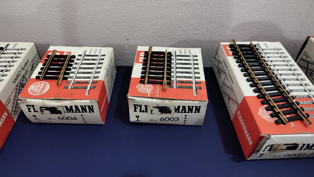 Fleischmann H0 - Γραμμές τρένου μοντελισμού (92) - Διαφορετικά Fleischmann H0 baanrails σε αυθεντικά κουτιά· χειρόγραφη λίστα με εμφανείς αριθμούς. #2.1