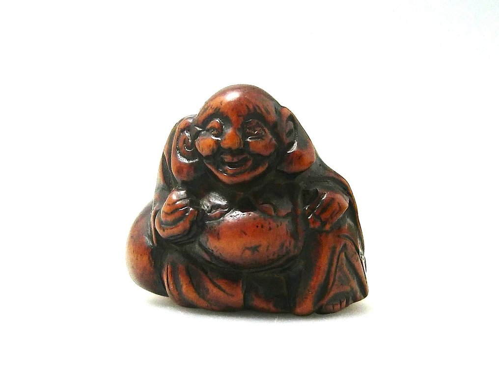 Ένα Νετσούσκε με τον Hotei, που φαίνεται να χαμογελά και κρατά το Ιερό Πετράδι καθώς αναπαύεται πάνω - Ξύλο - Ιαπωνία - Edo Period (1600-1868) #1.0